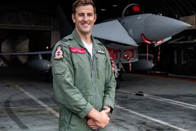 Flight Lieutenant Mathew Stannard in front of a 41 Test and Evaluation Squadron Typhoon in a Hardened Aircraft Shelter at 3 (Fighter) Squadron at RAF Coningsby.