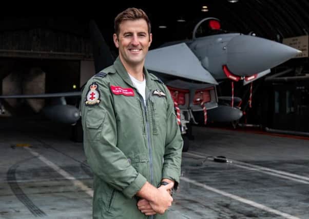 Flight Lieutenant Mathew Stannard in front of a 41 Test and Evaluation Squadron Typhoon in a Hardened Aircraft Shelter at 3 (Fighter) Squadron at RAF Coningsby.