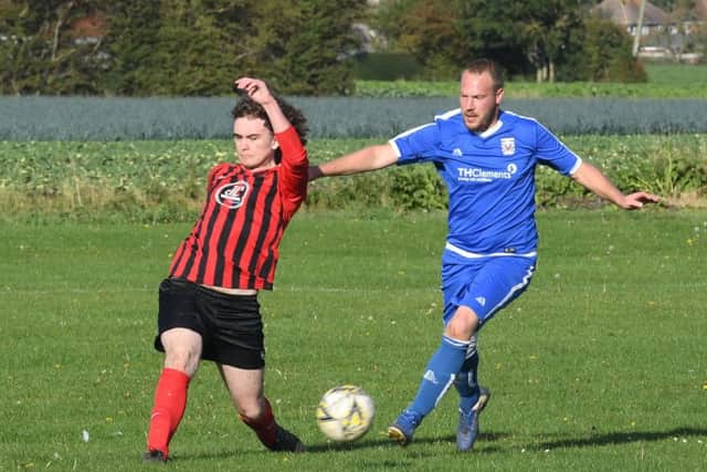 Benington (blue) v Woodhall Spa Res (red). Chris Lawson (blue), Jordan Barrand (red)