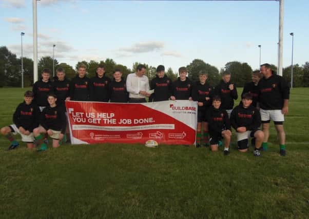 Buildbase branch manager Jamie Taylor with the Rasen U15s squad EMN-191014-130950002