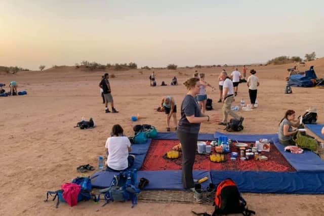 Picnic in the desert: The trekkers take a well-earned rest and tuck into food prepared by chefs.
