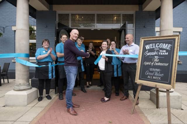 In safe hands ... Ex-Boston United goalkeeper Paul Bastock performing the ribbon-cutting duties at the re-launched Spirit of Endeavour pub.
