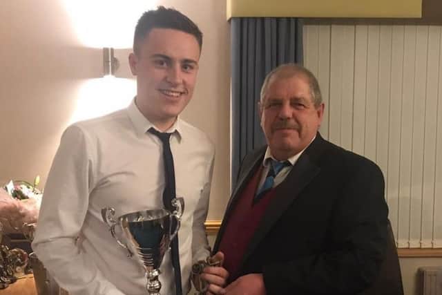 Kieran Brooker is presented with the First XI bowling award from Ben Jacob EMN-191024-111937002