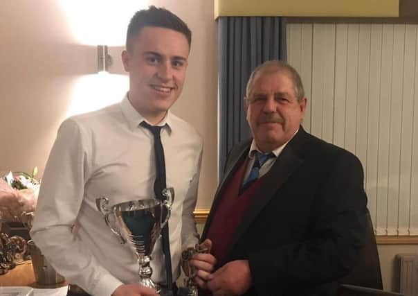 Kieran Brooker is presented with the First XI bowling award from Ben Jacob EMN-191024-111937002