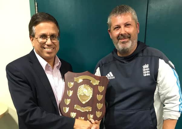Louth Taverners acting skipper Zubair Ahmed is presented with the champions shield by East Lindsay Sunday League chairman Justin Owen EMN-191024-124451002
