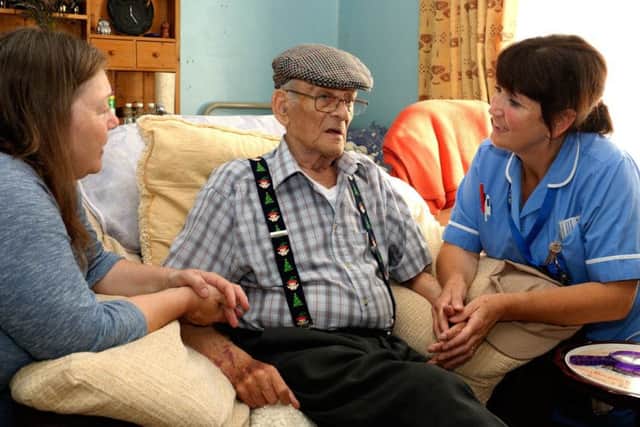 Marie Wootton (right) with a hospice resident and visitor.