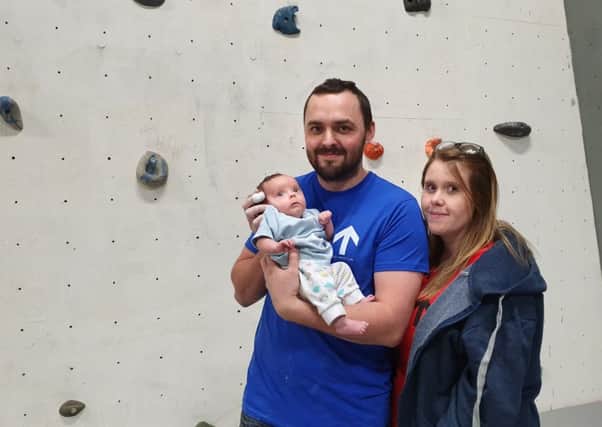 Darren, Heather, and baby Dougie at the Ascend Climbing Gym in Louth.