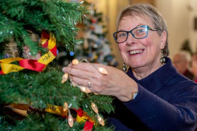 Pat Whitley popping lights on a Christmas Tree at last year's festival.