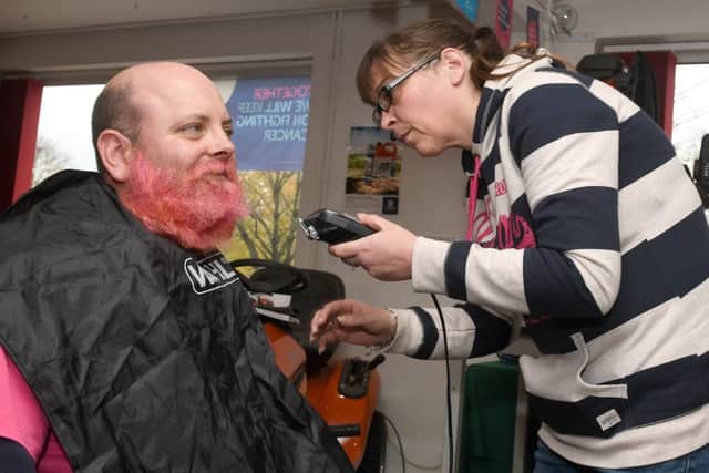 Simon Greenfield has his beard shaved off in aid of Cancer Research UK.