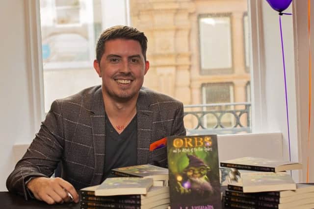 Adam Richardson with his new book.