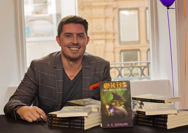 Adam Richardson with his new book.