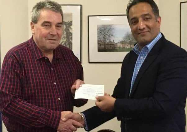 Harjit Bains, Worshipful Master of Hermes Lodge, presented the cheque to John Troughton.