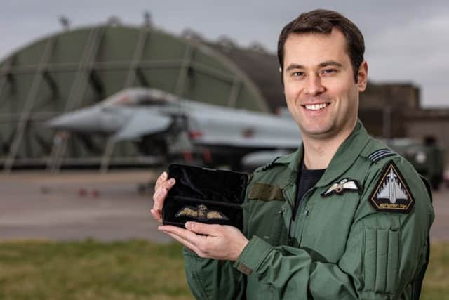 RAF Typhoon Pilot Flt Lt Brighty with the wings in front of his Typhoon. EMN-200124-141338001