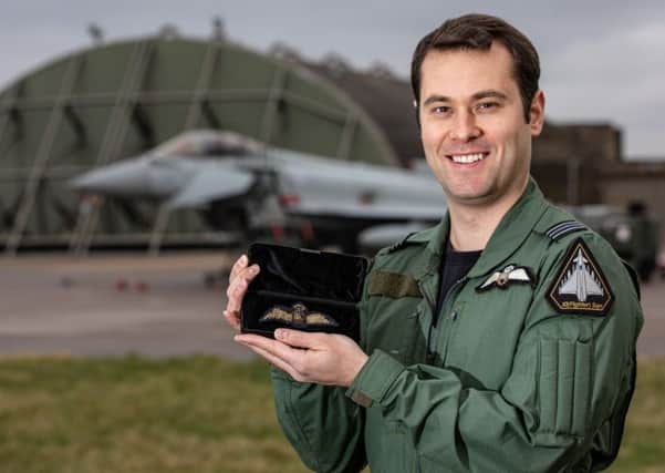 RAF Typhoon Pilot Flt Lt Brighty with the wings in front of his Typhoon. EMN-200124-141338001