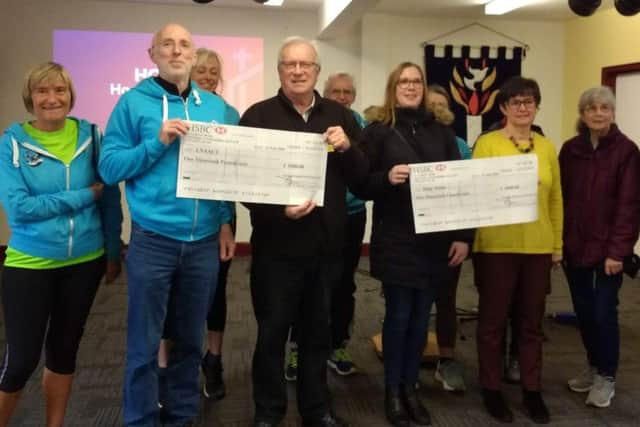 Mablethorpe Running Club members with representatives of the air ambulance and Hope House EMN-200224-113234002