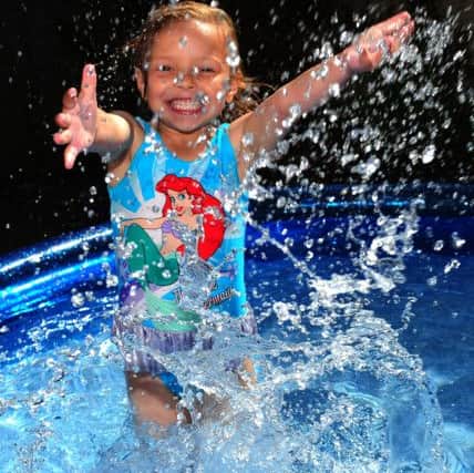 Kadie Lane, 4, cools down as the heatwave continues across the country. PA Photo Owen Humphreys.