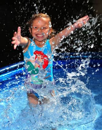 Kadie Lane, 4, cools down as the heatwave continues across the country. PA Photo Owen Humphreys.