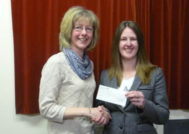 WI treasurer Barbara Pollard presents St Andrew's Hospice fundraiser Kelly Uprichard with a cheque for £125. EMN-140324-164302001