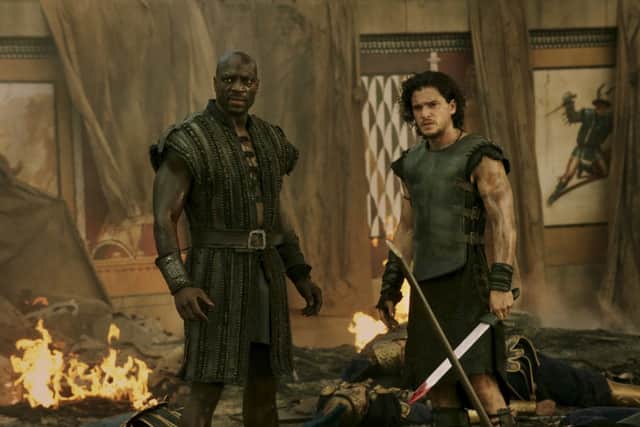 Adewale Akinnuoye-Agbaje as Atticus & Kit Harington as Milo in Pompeii. POS1401281450503405