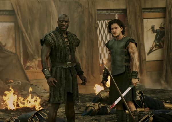 Adewale Akinnuoye-Agbaje as Atticus & Kit Harington as Milo in Pompeii. POS1401281450503405