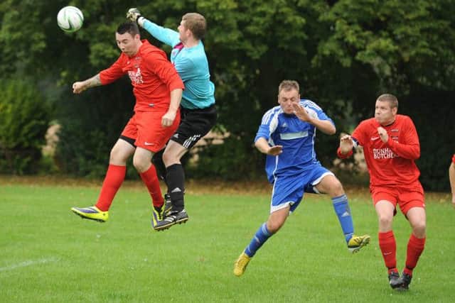 Decland Sands competing for the ball with Ruskington goalkeeper Ben Jackson.