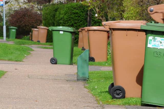 Brown and green recycling bins being collected in Werrington, Peterborough.
