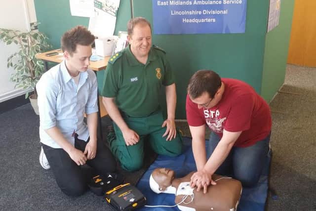Steven Pratten with an automated external defibrillator.