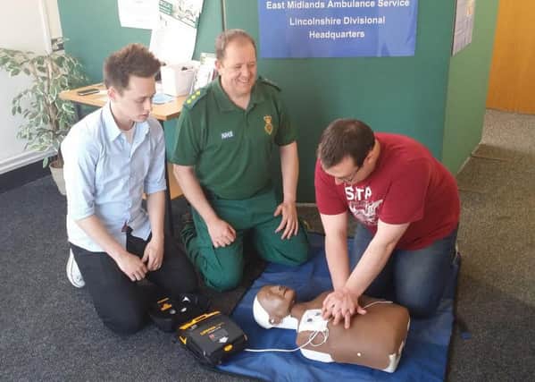 Steven Pratten with an automated external defibrillator.