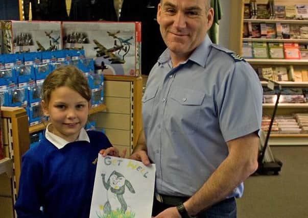 Tattershall Primary School pupil Holly presents her homemade 'Get Well Soon' card for the BBMF's Thumper EMN-151005-095804001