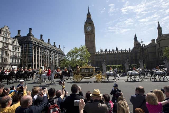 Britain's Queen Elizabeth II arrives in a carriage at the Houses of Parliament in a procession from Buckingham Palace in London to deliver her speech. Photo/PA LMD101