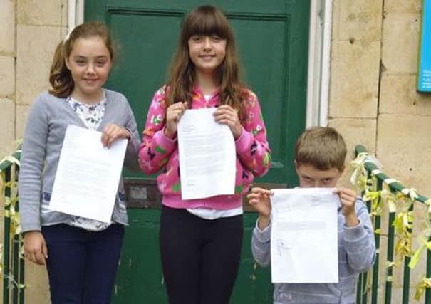 Sian (11), Rhiannon (13) and Rhys Morgan Plowright (seven) with their letters to Michelle Obama
