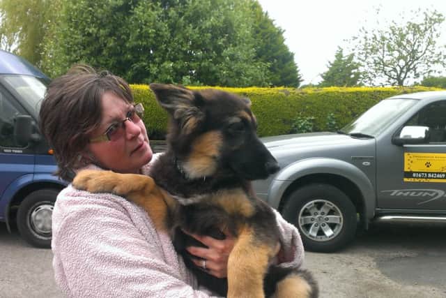 House owner Sharon Butcher with a puppy rescued from the fire.