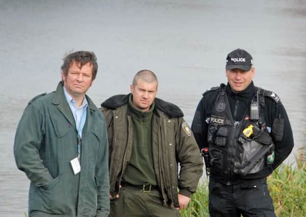 Adrian Saunders of the Environment Agency, Rafal Sosnowski from the Polish fishing authorities, Sergeant Dave Robinson of Lincolnshire Police carry out checks as part of Operation Traverse in Spalding.  Photo by Tim Wilson