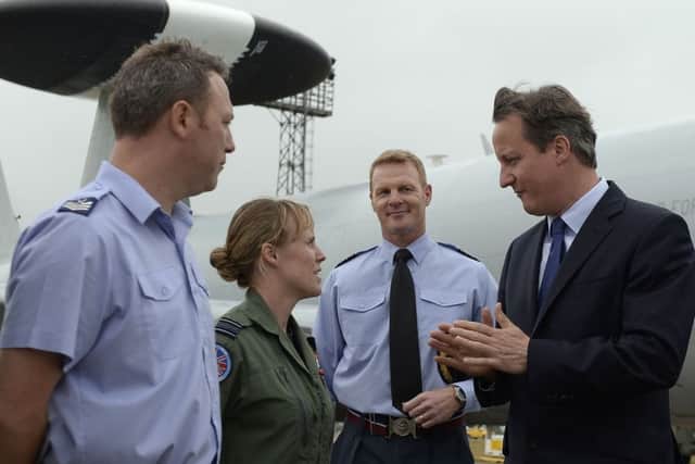 Prime Minister David Cameron meets Flight Lieutenant Sarah Vamplew (second form left) during a visit to RAF Coningsby in Lincolnshire. PRESS ASSOCIATION Photo. Picture date: Monday July 13, 2015. See PA story DEFENCE Cameron. Photo credit should read: Joe Giddens/PA Wire EMN-150714-102047001