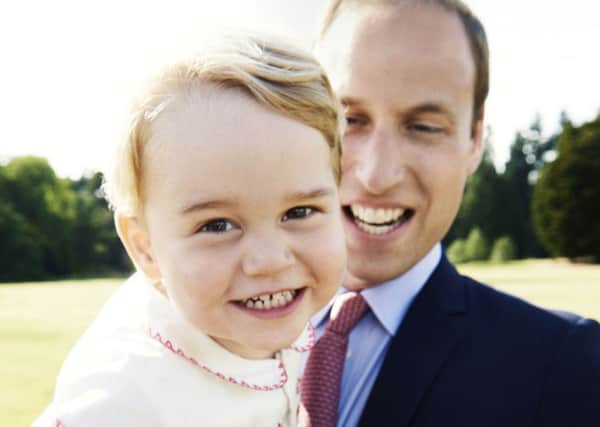 Prince George, who celebrates his second birthday on Tuesday, with his father, the Duke of Cambridge in the gardens at Sandringham House. Photo: Mario Testino/PA Wire ROYAL_George_143115.JPG