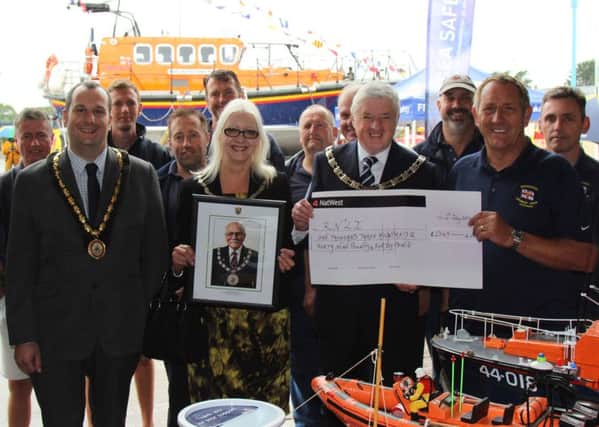 SKDC chairman Coun Ray Wootten hands over the cheque to coxswain Ray Chapman, accompanied by Coun Linda Wootten and Mayor of Skegness, Coun Carl Macey (front row, left) and RNLI Skegness Lifeboat crew.