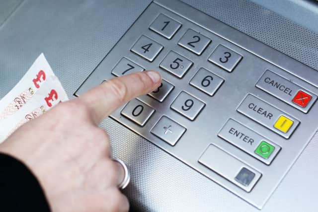 Money being taken out of a cash machine, as shop owners said they could soon be forced to start charging customers to use cash machines or remove them altogether as a result of changes to the way they are taxed.