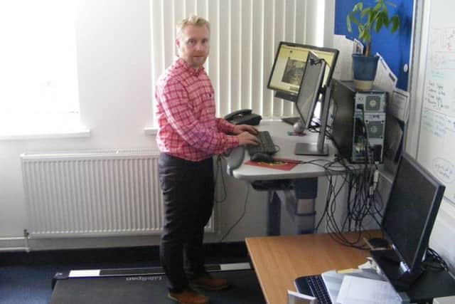 Dr Mark Tully on his treadmill desk at work in Belfasts Queen's University.