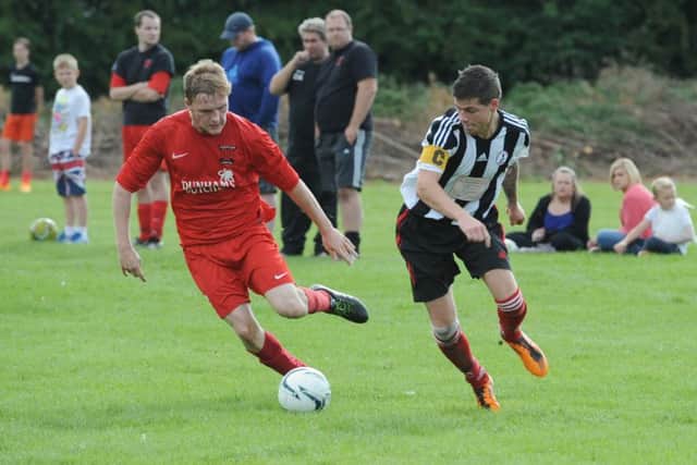 Kirton's Kurt West and Spilsby's Adam Dales do battle.
