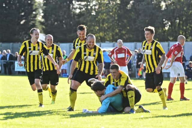 Ricky Drury is congratulated after his dramatic goal. Photo: STEVE RELF
