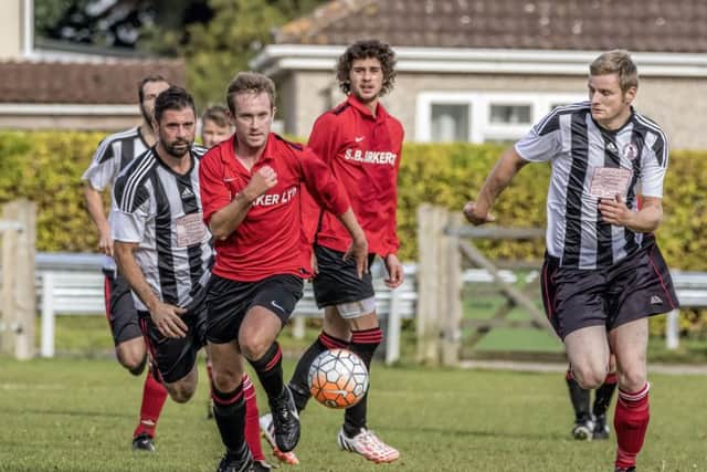 Coningsbys Andy Kelly breaks away for a brief solo run during the match with Spilsby Town on Saturday. Photo by Oscarpix Imaging.