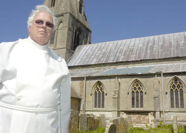 Rev Charles Sowden outside Frampton St Mary's Chruch which has had lead stolen from the roof. ENGEMN00120110205141942