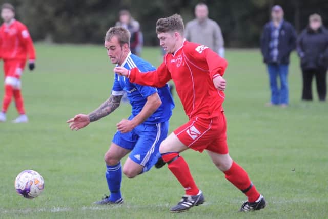 Fishtoft's Jamie Kuhn battles with Swineshead's Dean Granger.