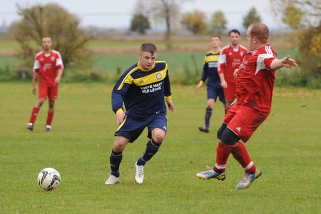 Billinghay's Simon Creasey clashes with Old Leake's James Leafe.