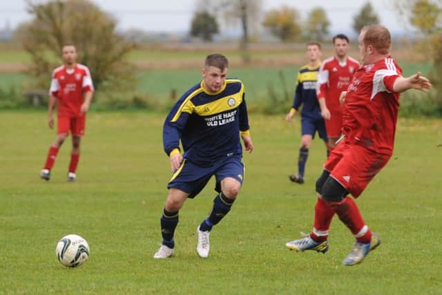 Billinghay's Simon Creasey clashes with Old Leake's James Leafe.