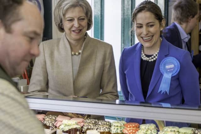 Theresa May and Victoria Atkins with Russ Hirst EMN-150104-120628001