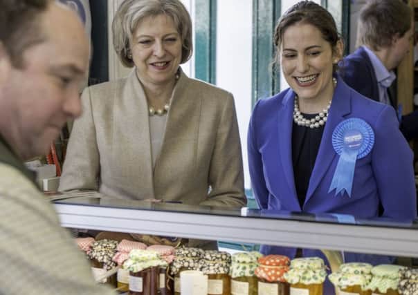 Theresa May and Victoria Atkins with Russ Hirst EMN-150104-120628001