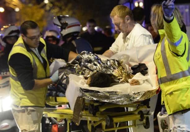 Rescuers evacuate an injured person near the Bataclan concert hall. Picture: AFP/Getty Images