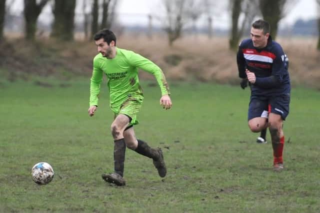 Boston Titans' Matt Howden bursts away from FC Hammers' Diogo Garcia.