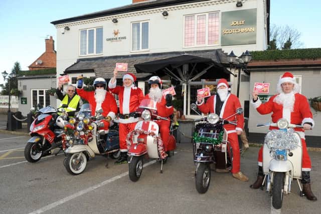 Sleaford All Knighters Scooter Club members setting off from the Jolly Scotchman to deliver mince pies and sherry donated by the pub, to Roxholm Nursing Home. From left - Roy Workman, Rob Castle, Michael Norbury - Jolly Scotchman general manager, Graham Foster, Andy Priestley and Paul Franks. EMN-151221-134349001